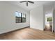 Bedroom with hardwood floors, large window, and doorway to another bedroom at 809 Maxwell St, Orlando, FL 32804