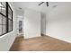 Bright bedroom with hardwood floors and doorway to another room, perfect for a growing Gathering at 809 Maxwell St, Orlando, FL 32804