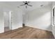 Bright bedroom features hardwood floors, ceiling fan, with ensuite bathroom and walk-in closet entrances at 809 Maxwell St, Orlando, FL 32804