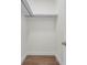 A minimalistic walk-in closet space with hardwood floors and a sturdy hanging rod system at 809 Maxwell St, Orlando, FL 32804