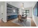 Elegant dining room with a stylish buffet, modern light fixture and blue accent wall at 809 Maxwell St, Orlando, FL 32804