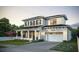 Two-story house with light brick exterior, gray roof, and a two-car garage at 809 Maxwell St, Orlando, FL 32804