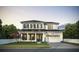 Two-story house with white brick, dark roof, and green door at 809 Maxwell St, Orlando, FL 32804