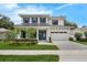 Charming two-story home with a manicured lawn, a paved driveway, and a beautiful front door and shutters at 809 Maxwell St, Orlando, FL 32804