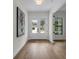 Spacious foyer with hardwood floors, white walls, and a view of the front door and a large window at 809 Maxwell St, Orlando, FL 32804