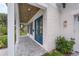 View of the house's entryway with a blue double door, wooden ceiling and white brick walls at 809 Maxwell St, Orlando, FL 32804