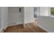 The hallway features hardwood floors, leading to a laundry area and a living space with abundant light at 809 Maxwell St, Orlando, FL 32804