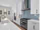Gourmet kitchen featuring stainless steel appliances, sleek cabinetry, and a modern backsplash at 809 Maxwell St, Orlando, FL 32804