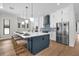 Modern kitchen featuring a large island with seating, stainless steel appliances, and stylish pendant lighting at 809 Maxwell St, Orlando, FL 32804