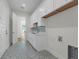 Functional laundry room with ample counter space, white cabinetry, and eye-catching flooring at 809 Maxwell St, Orlando, FL 32804