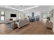 Open-concept living area with modern fireplace, white cabinets, and stainless steel appliances at 809 Maxwell St, Orlando, FL 32804
