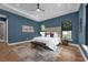 A stylish bedroom boasts a tufted headboard, with a decorative rug and dark blue accent wall at 809 Maxwell St, Orlando, FL 32804