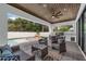 Covered patio with ceiling fan overlooks a sparkling pool and outdoor kitchen, perfect for entertaining and relaxation at 809 Maxwell St, Orlando, FL 32804