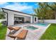 Backyard with a sparkling pool, spa, patio area, and well-manicured lawn creating an inviting outdoor living space at 809 Maxwell St, Orlando, FL 32804
