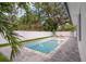 Sparkling pool with a privacy fence, surrounded by lush greenery and lounge chairs at 809 Maxwell St, Orlando, FL 32804