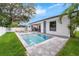 Beautiful backyard with a sparkling pool, lounge chairs, and outdoor kitchen at 809 Maxwell St, Orlando, FL 32804