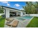 Backyard oasis with a sparkling pool, spa, covered patio, and lounge chairs, perfect for outdoor relaxation and entertaining at 809 Maxwell St, Orlando, FL 32804