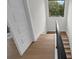 A bright stairway features hardwood steps and a contrasting black railing, illuminated by a natural light at 809 Maxwell St, Orlando, FL 32804