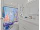 Bright bathroom with white vanity, and a whimsical Finding Nemo shower curtain at 8118 Yellow Crane Dr, Kissimmee, FL 34747