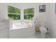 Bathroom with corner soaking tub and separate toilet at 8118 Yellow Crane Dr, Kissimmee, FL 34747