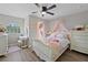 Bedroom with floral bedding and a ceiling fan at 8118 Yellow Crane Dr, Kissimmee, FL 34747