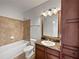 Guest bathroom with tub, vanity, and granite countertop at 914 Charo Pkwy # 112, Davenport, FL 33897