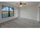 Bright bedroom featuring carpet, large window and door to patio at 914 Charo Pkwy # 112, Davenport, FL 33897