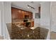 Modern kitchen with dark wood cabinets and granite countertops at 914 Charo Pkwy # 112, Davenport, FL 33897