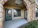 Private patio with stonework and double doors at 914 Charo Pkwy # 112, Davenport, FL 33897