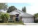 Brick and gray two-story house with gray roof, landscaping, and a two-car garage at 1254 Chessington Cir, Lake Mary, FL 32746