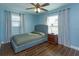 Cozy bedroom with light blue walls and wood-look tile floors at 1354 Tierra Cir, Winter Park, FL 32792