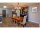 Dining room with wooden table and view into kitchen at 1354 Tierra Cir, Winter Park, FL 32792