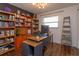 Bright home office features built-in shelving and wood desk at 1354 Tierra Cir, Winter Park, FL 32792