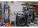 Laundry room with washer, dryer, sink, and hot water heater at 1354 Tierra Cir, Winter Park, FL 32792