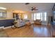 Living room with hardwood floors, comfortable seating and a large TV at 1354 Tierra Cir, Winter Park, FL 32792
