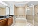 Elegant bathroom with double sinks, walk-in shower, and soaking tub at 1368 Centre Court Ridge Dr # 104, Reunion, FL 34747