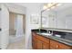 Bathroom with granite countertop, large mirror and shower/tub combo at 1368 Centre Court Ridge Dr # 104, Reunion, FL 34747