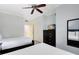 Bright bedroom with two twin beds, ceiling fan, and built-in dresser at 1368 Centre Court Ridge Dr # 104, Reunion, FL 34747
