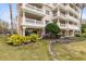 Condo building with balconies, landscaping, and a tranquil atmosphere at 1368 Centre Court Ridge Dr # 104, Reunion, FL 34747