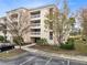 Condo building with ample parking and lush landscaping at 1368 Centre Court Ridge Dr # 104, Reunion, FL 34747
