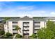 Three-story building with balconies and lush landscaping at 1368 Centre Court Ridge Dr # 104, Reunion, FL 34747