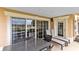 Covered patio with seating area and sliding glass doors at 1368 Centre Court Ridge Dr # 104, Reunion, FL 34747