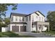 Two-story home with a modern design, dark brown garage doors, and landscaping at 1417 Miller Ave, Winter Park, FL 32789