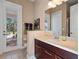 Bathroom with vanity, toilet, and direct access to the backyard at 14442 Avenue Of The Rushes, Winter Garden, FL 34787