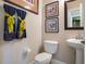Clean bathroom with pedestal sink, toilet and decorative towels at 14442 Avenue Of The Rushes, Winter Garden, FL 34787