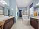 Elegant bathroom with double vanity, soaking tub, and walk-in shower at 14442 Avenue Of The Rushes, Winter Garden, FL 34787