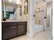 Bathroom with tub, shower, and dark wood vanity at 14442 Avenue Of The Rushes, Winter Garden, FL 34787