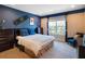 Spacious bedroom with dresser, seating, and large window at 14442 Avenue Of The Rushes, Winter Garden, FL 34787