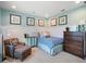 Bright bedroom featuring a bed, dresser, and comfy armchair at 14442 Avenue Of The Rushes, Winter Garden, FL 34787
