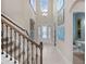 Bright and airy entryway with high ceilings, a staircase, and a view to the living room at 14442 Avenue Of The Rushes, Winter Garden, FL 34787